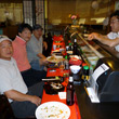 People enjoying sushi at the bar.